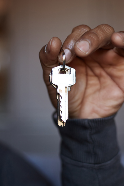 Locksmith in Balham and South London young adult male hand holding silver house keys up